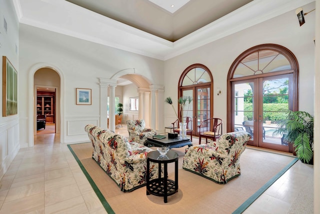 tiled living room featuring french doors, a high ceiling, and a wealth of natural light