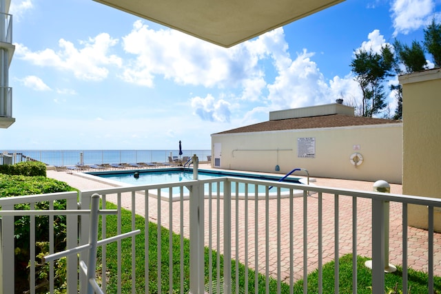 view of pool with a water view