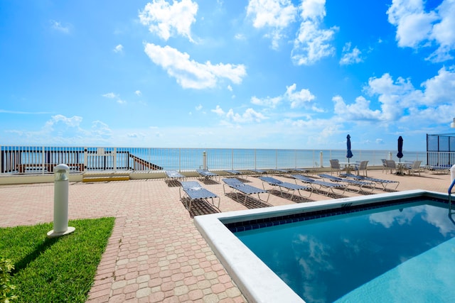 view of swimming pool with a water view