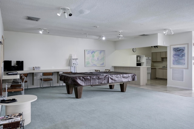 playroom featuring pool table, a textured ceiling, light carpet, and track lighting