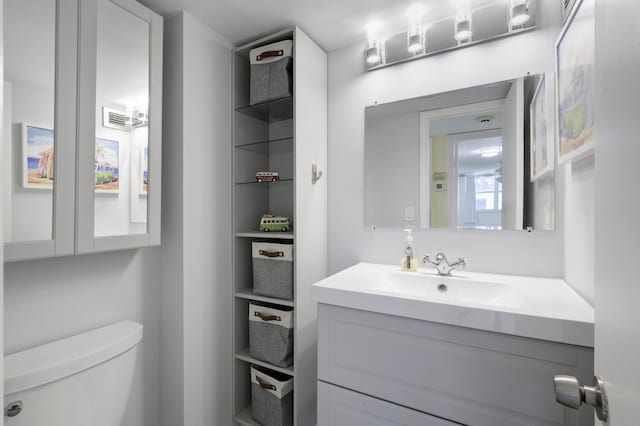 bathroom featuring toilet and vanity