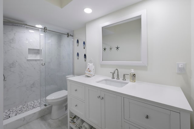 bathroom with tiled shower, tile patterned flooring, toilet, and vanity