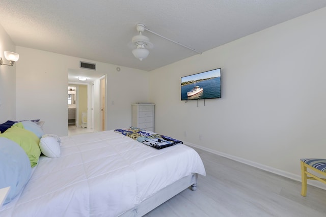 bedroom with ceiling fan and light wood-type flooring