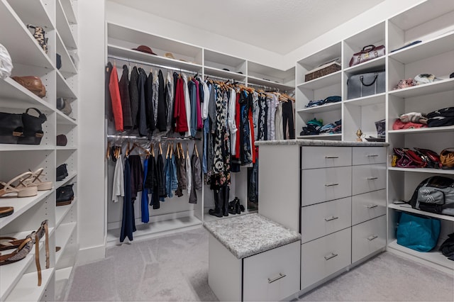 spacious closet featuring light carpet