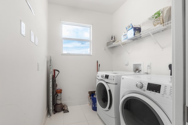 laundry area featuring light tile patterned floors and separate washer and dryer