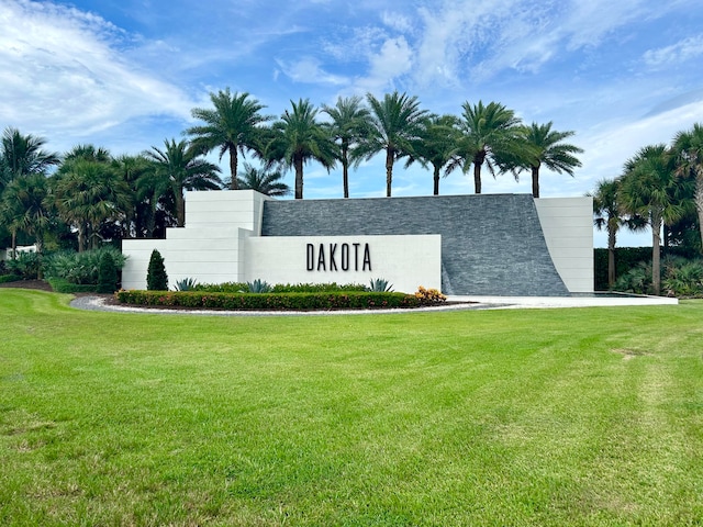 community / neighborhood sign with a lawn