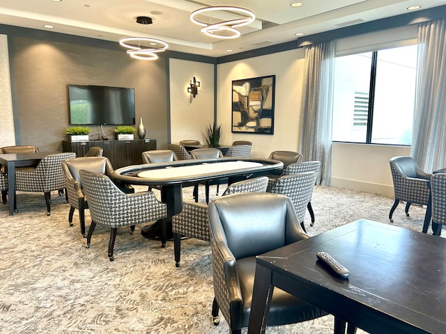 recreation room with a tray ceiling, carpet floors, and plenty of natural light