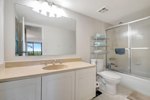 full bathroom featuring combined bath / shower with glass door, toilet, tile patterned floors, and vanity