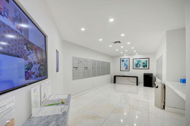 interior space with a mail area and light tile patterned floors