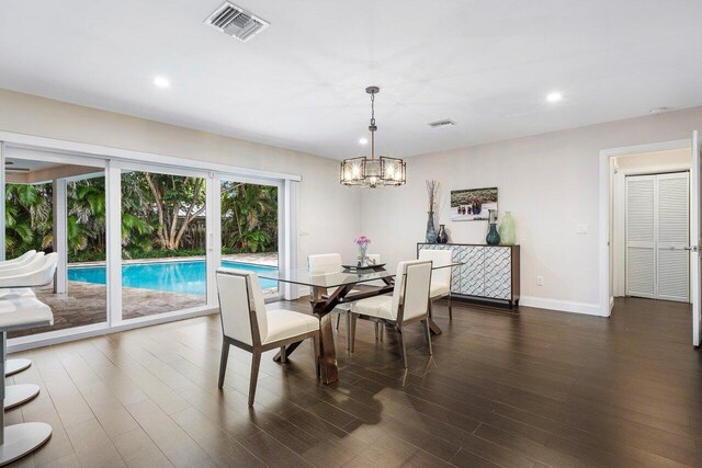 dining space with a notable chandelier and hardwood / wood-style floors