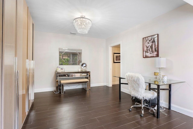 office with baseboards, wood finished floors, visible vents, and a notable chandelier