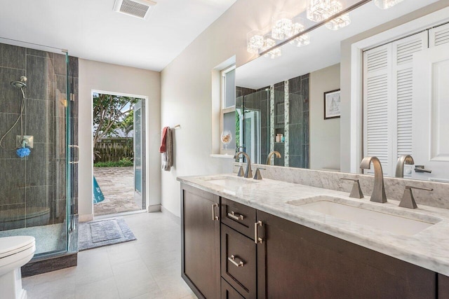 full bath with toilet, a stall shower, visible vents, and a sink