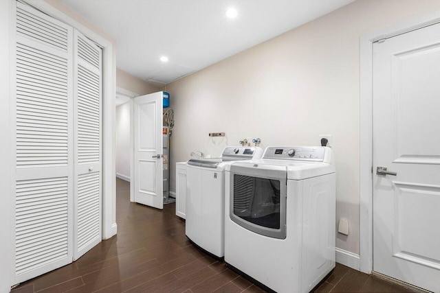 laundry area featuring washing machine and dryer and dark wood-type flooring