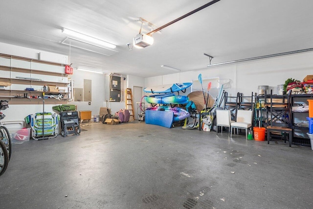 garage with a garage door opener and electric panel