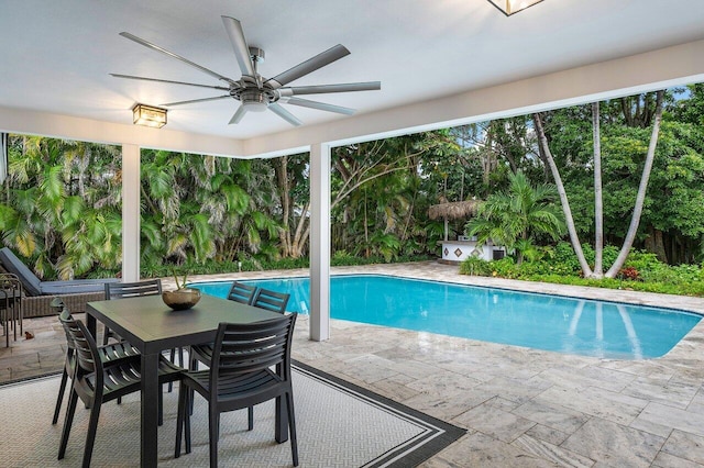 view of swimming pool with ceiling fan and a patio