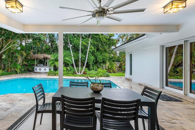 outdoor pool with outdoor dining space, a patio, and ceiling fan