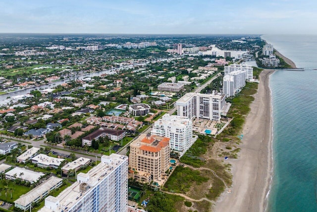 drone / aerial view featuring a city view, a beach view, and a water view