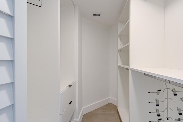 spacious closet with light tile patterned floors