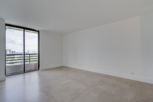 unfurnished room with expansive windows