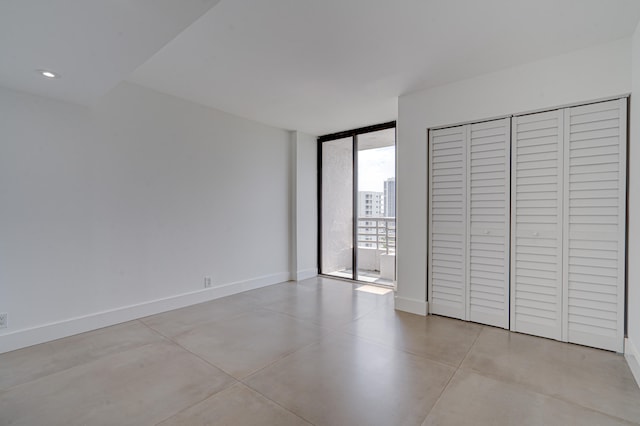 unfurnished bedroom featuring access to outside and expansive windows