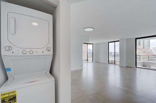 clothes washing area with stacked washer and dryer