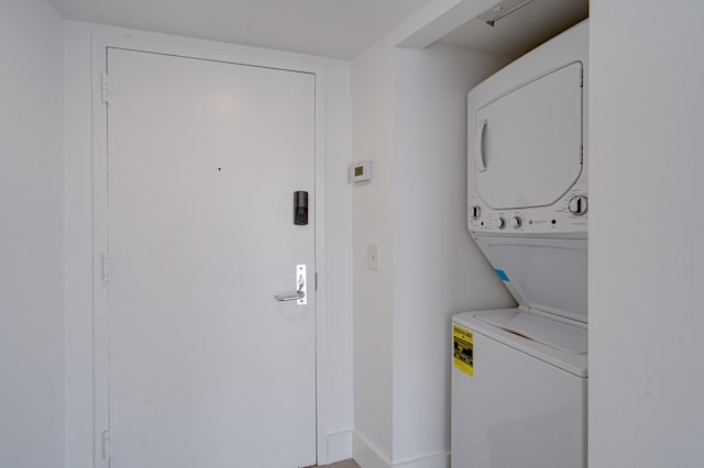 laundry area featuring stacked washer / drying machine