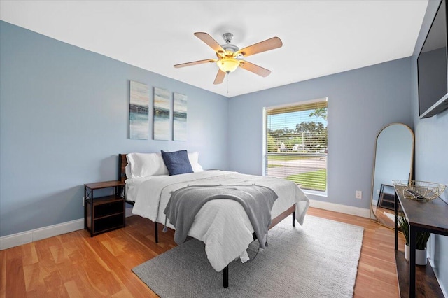 bedroom featuring light wood-type flooring and ceiling fan