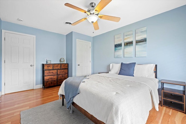 bedroom with light wood-type flooring and ceiling fan