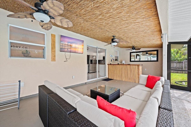 living room featuring vaulted ceiling, concrete floors, and ceiling fan