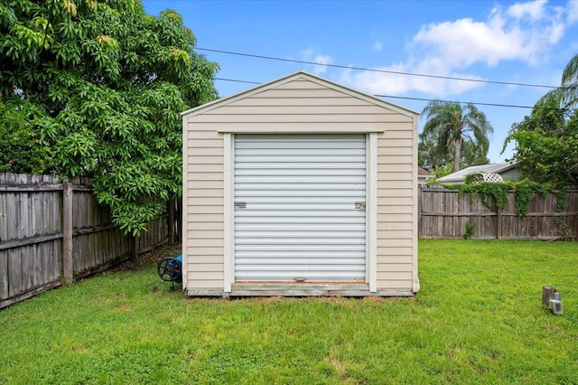 view of outbuilding with a yard