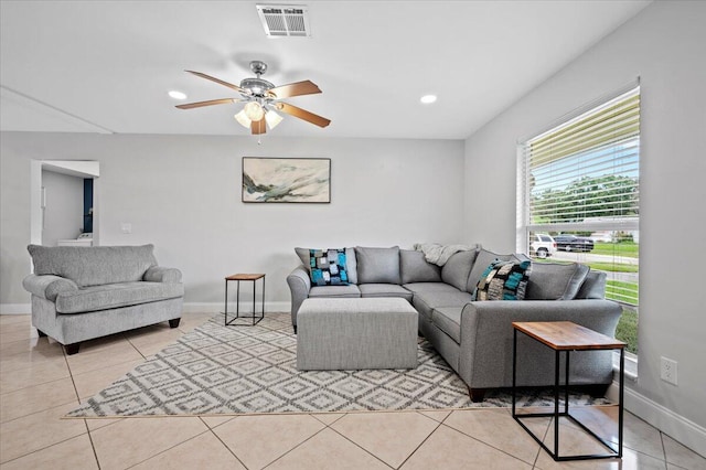 living room with ceiling fan and light tile patterned floors