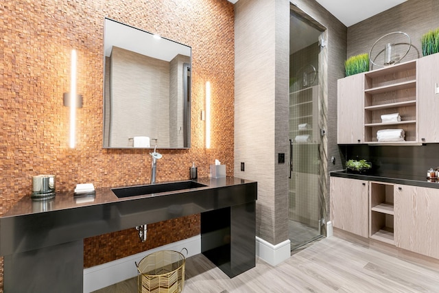 bathroom featuring wood-type flooring, vanity, and walk in shower