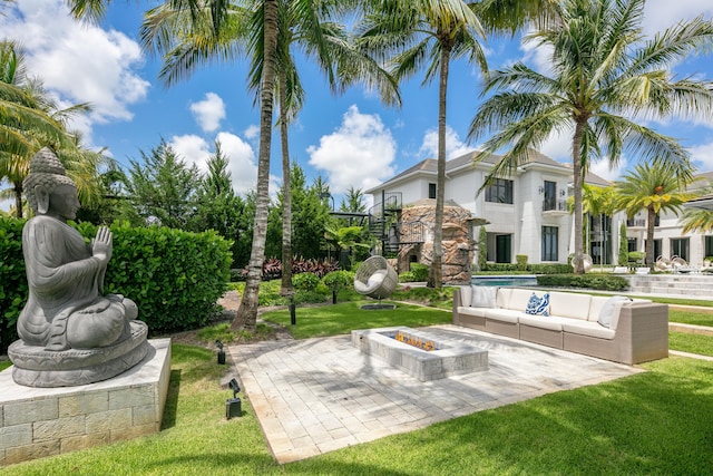 exterior space featuring an outdoor living space with a fire pit and a patio