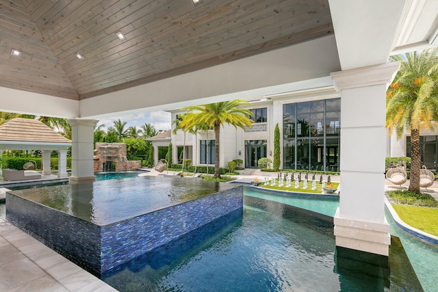 view of swimming pool with a gazebo and pool water feature