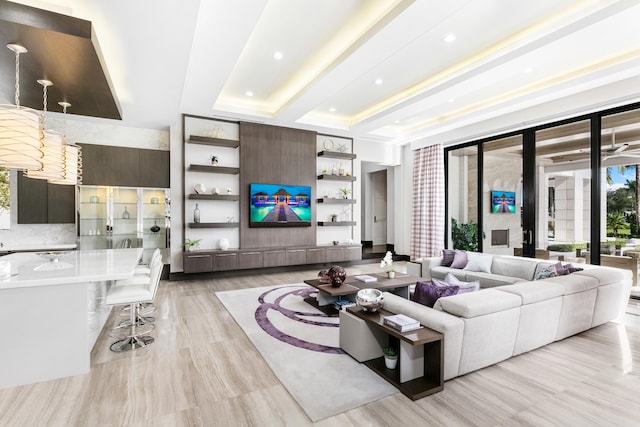 interior space featuring a tray ceiling and light hardwood / wood-style flooring