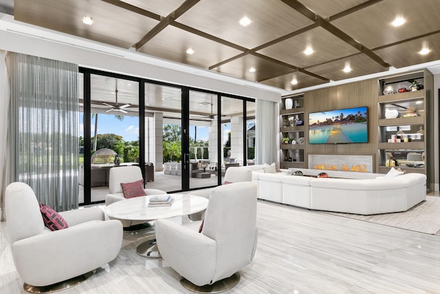 living room with ceiling fan, coffered ceiling, wooden walls, french doors, and light hardwood / wood-style floors