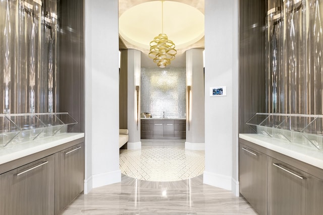 bathroom with a notable chandelier, tile patterned flooring, and vanity