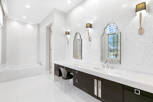 bathroom with tile patterned flooring, a tub to relax in, and vanity