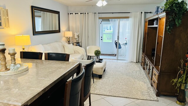 bedroom featuring access to outside, ceiling fan, and light tile patterned floors