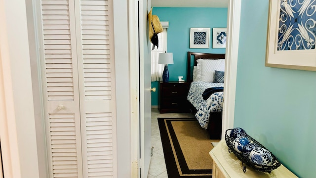 tiled bedroom featuring a closet