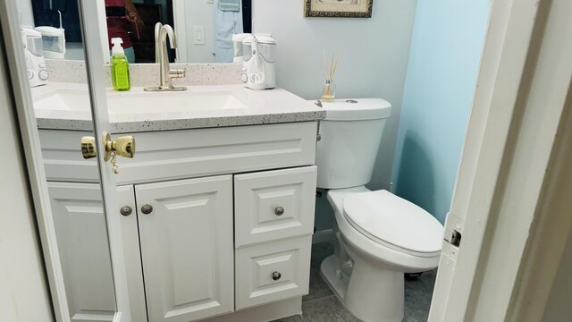 bathroom featuring vanity, toilet, and tile patterned floors