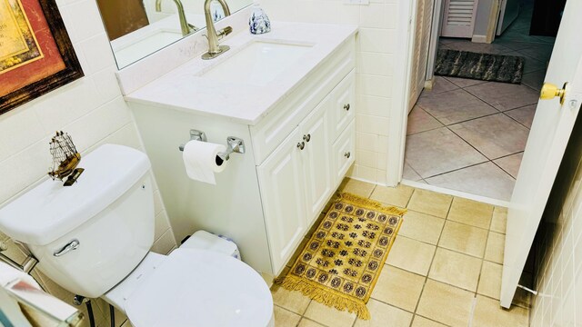 bathroom with vanity, toilet, and tile patterned floors