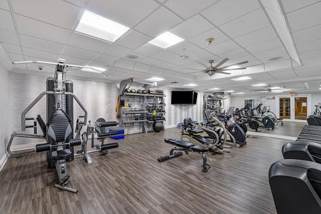 gym featuring hardwood / wood-style floors, a paneled ceiling, and ceiling fan