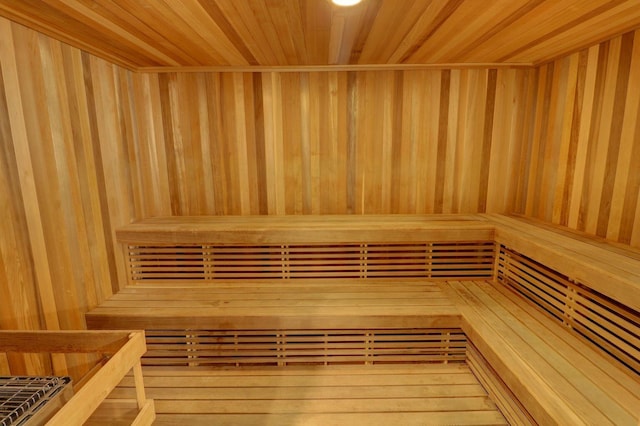 view of sauna featuring wood ceiling, hardwood / wood-style flooring, and wooden walls