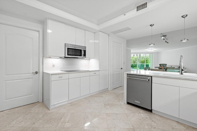 kitchen with crown molding, hanging light fixtures, stainless steel appliances, sink, and white cabinetry