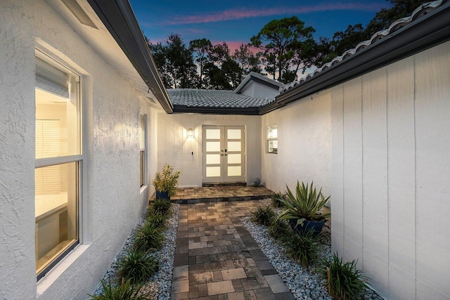 view of exterior entry at dusk