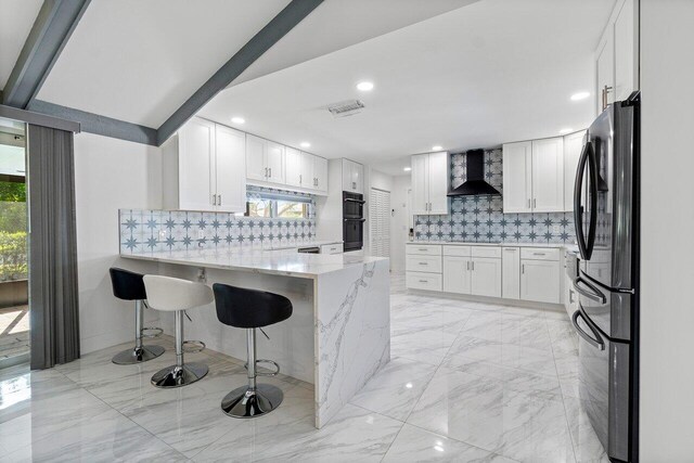 kitchen featuring lofted ceiling with beams, wine cooler, decorative backsplash, kitchen peninsula, and white cabinets