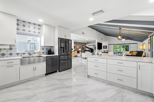 kitchen featuring black fridge, stainless steel dishwasher, backsplash, white cabinetry, and lofted ceiling with beams