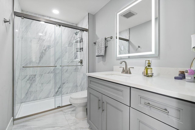 bathroom with vanity, toilet, and an enclosed shower