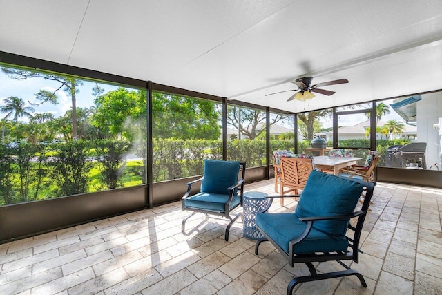 sunroom featuring ceiling fan